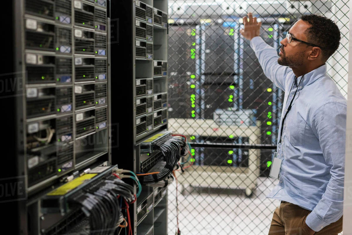 ICT specialist inspecting equipment in a server room, from the company profile